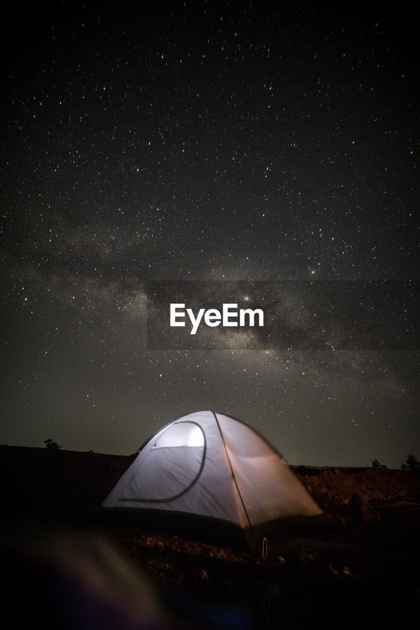 Tent on land against sky at night