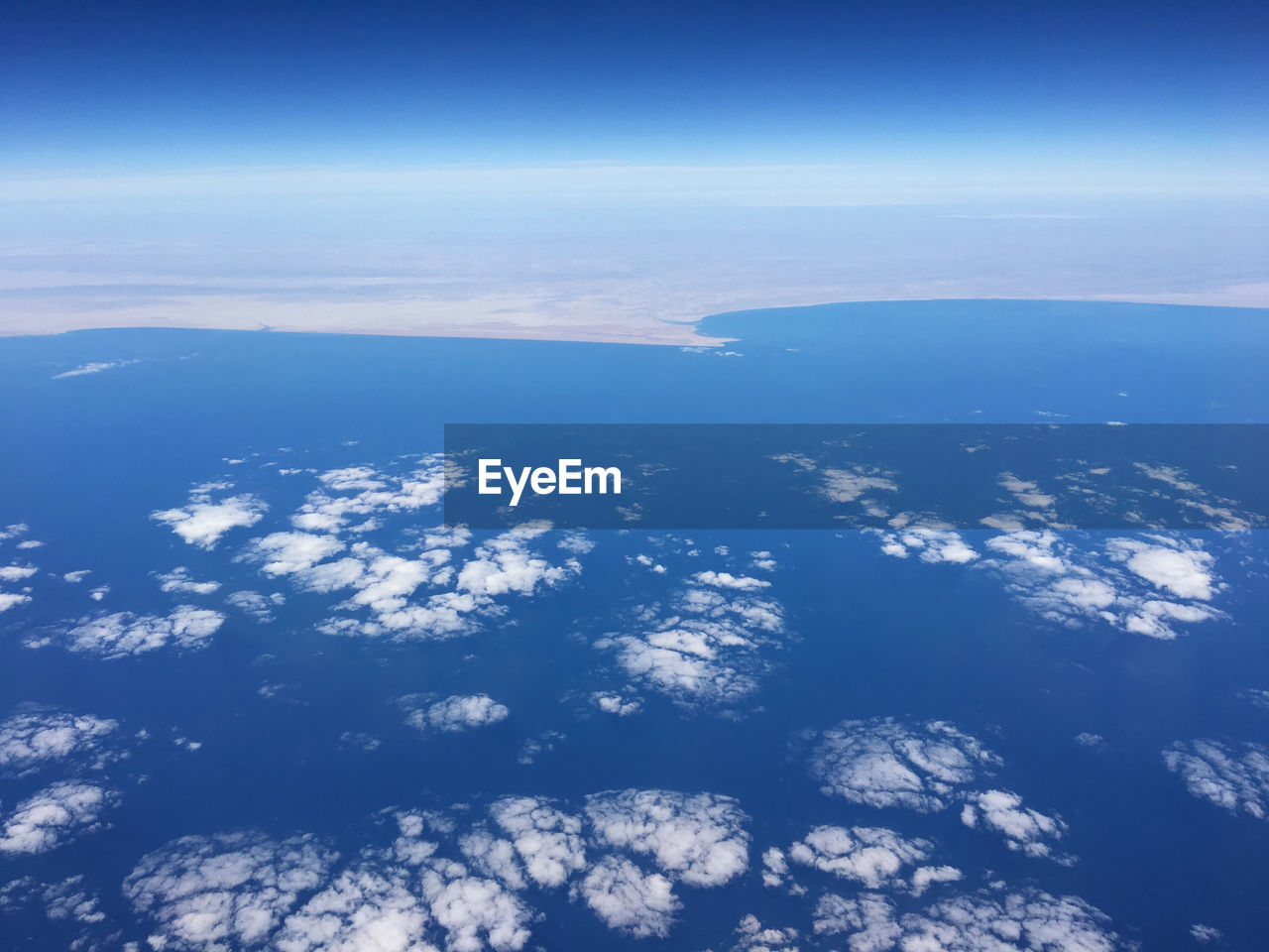 AERIAL VIEW OF SEA AND LANDSCAPE AGAINST SKY