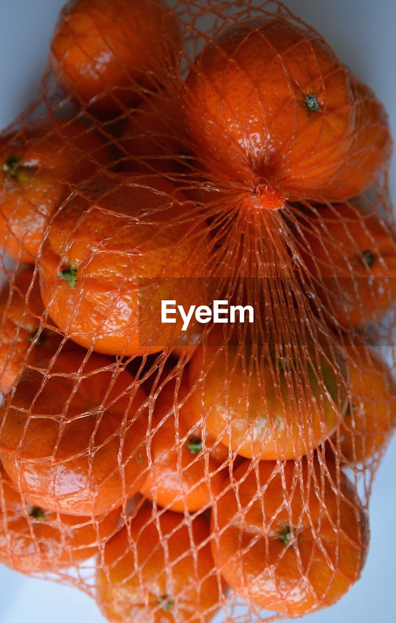 Close-up of oranges in net