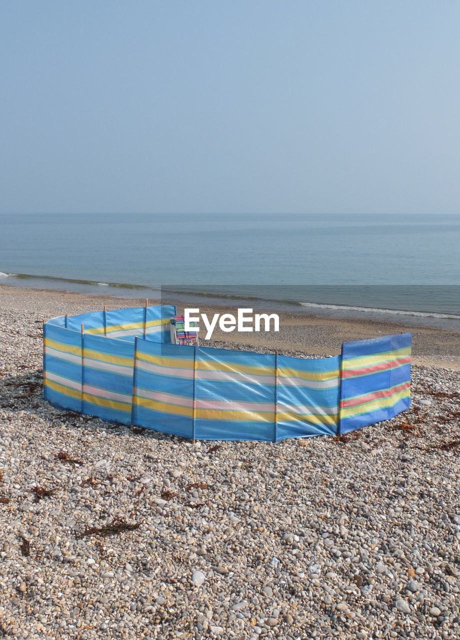 Scenic view of beach against blue sky