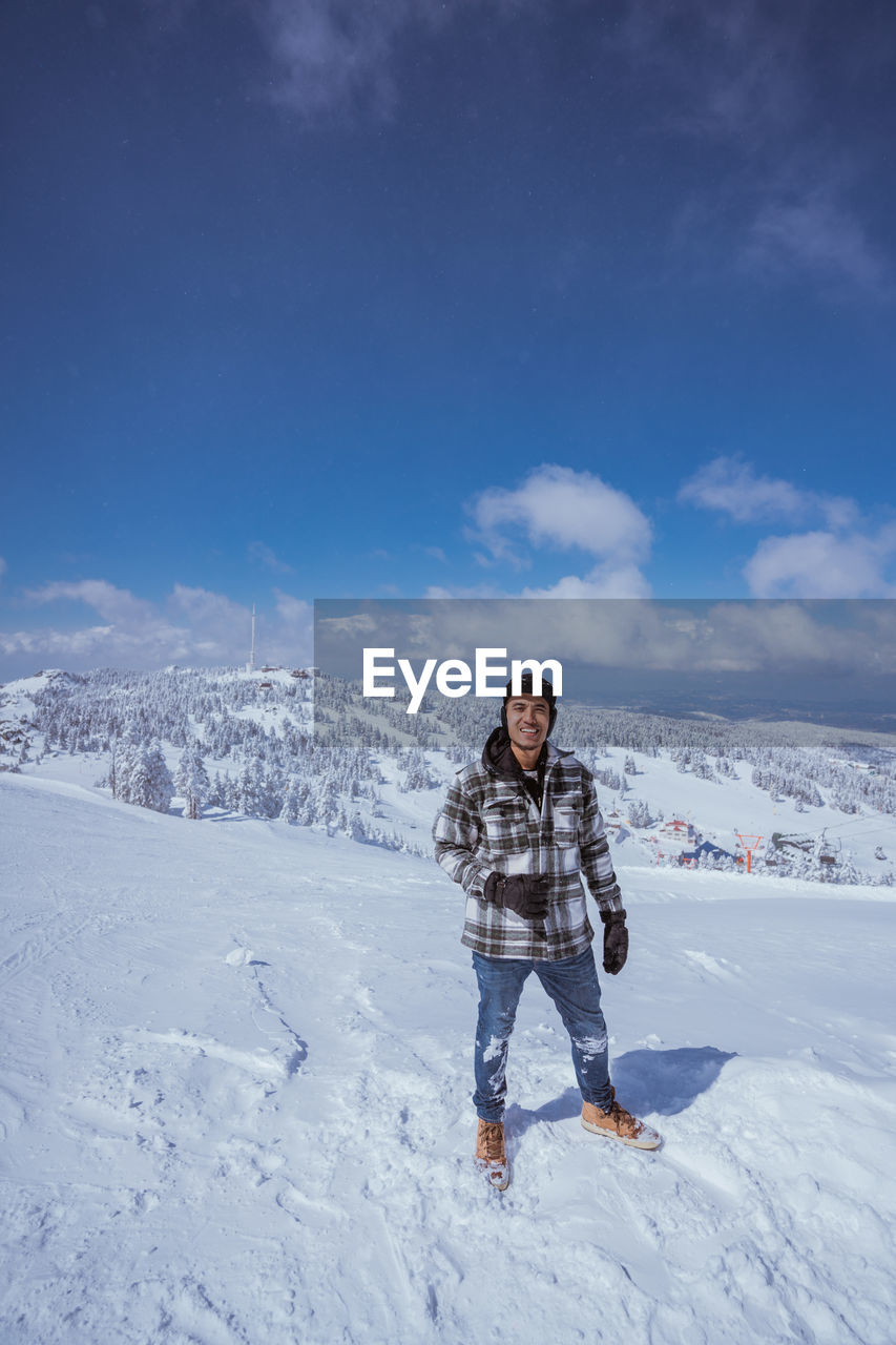 full length of young woman skiing on snow