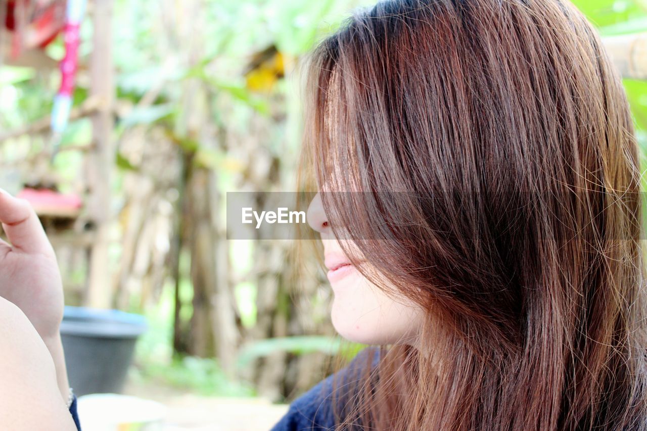 Close-up of young woman with brown hair