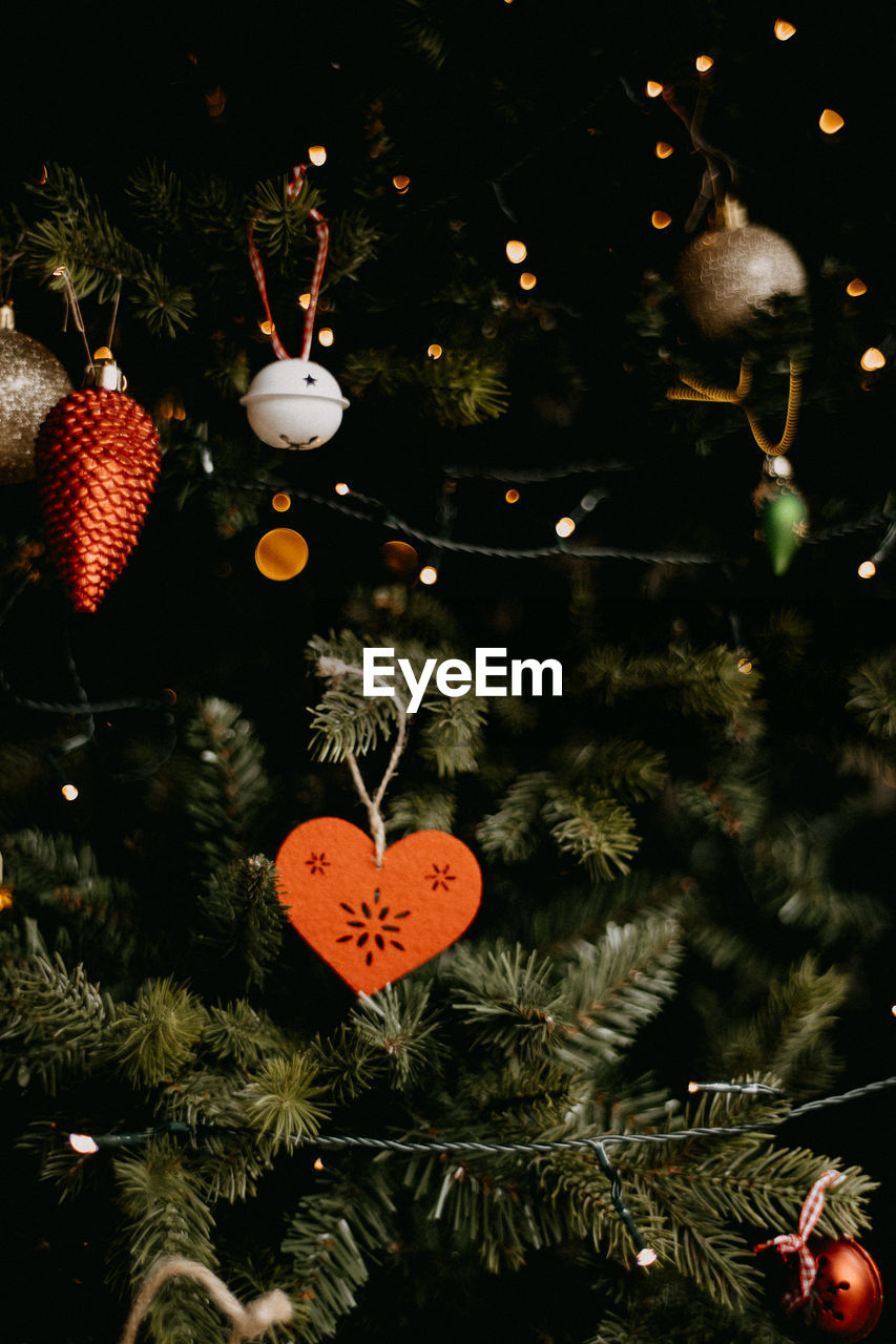 Decorations and ornaments hanging on a christmas tree in the festive season, indoors