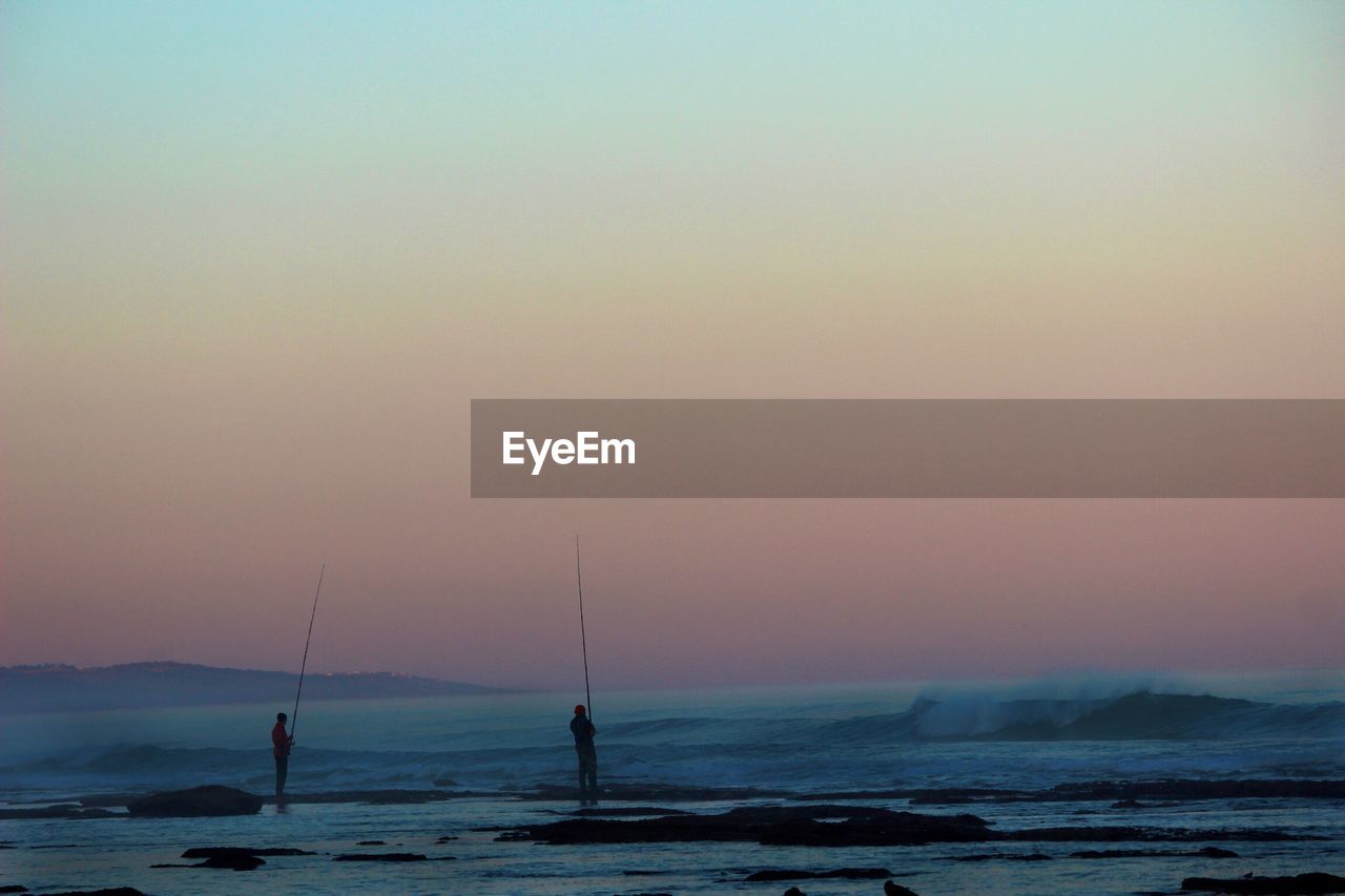 Scenic view of sea against clear sky during sunset