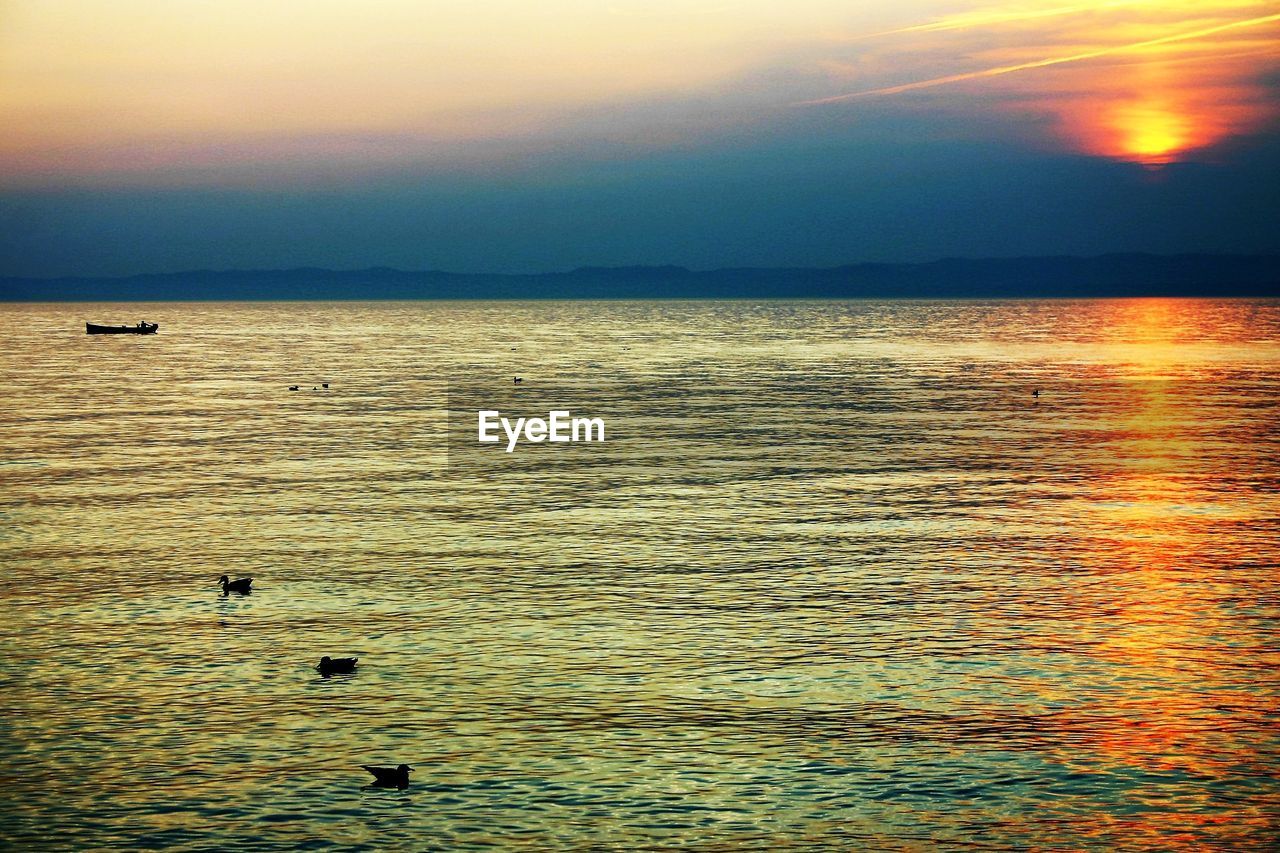 SCENIC VIEW OF BEACH AGAINST SKY DURING SUNSET