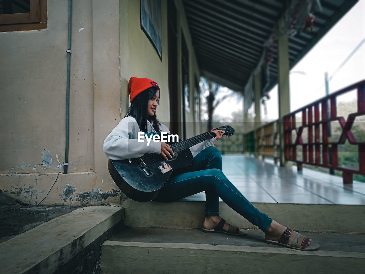 Side view of women playing guitar