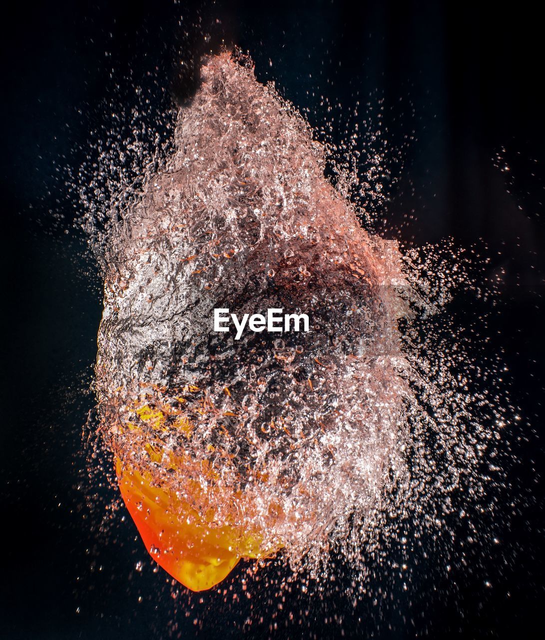 Close-up of water bomb against black background