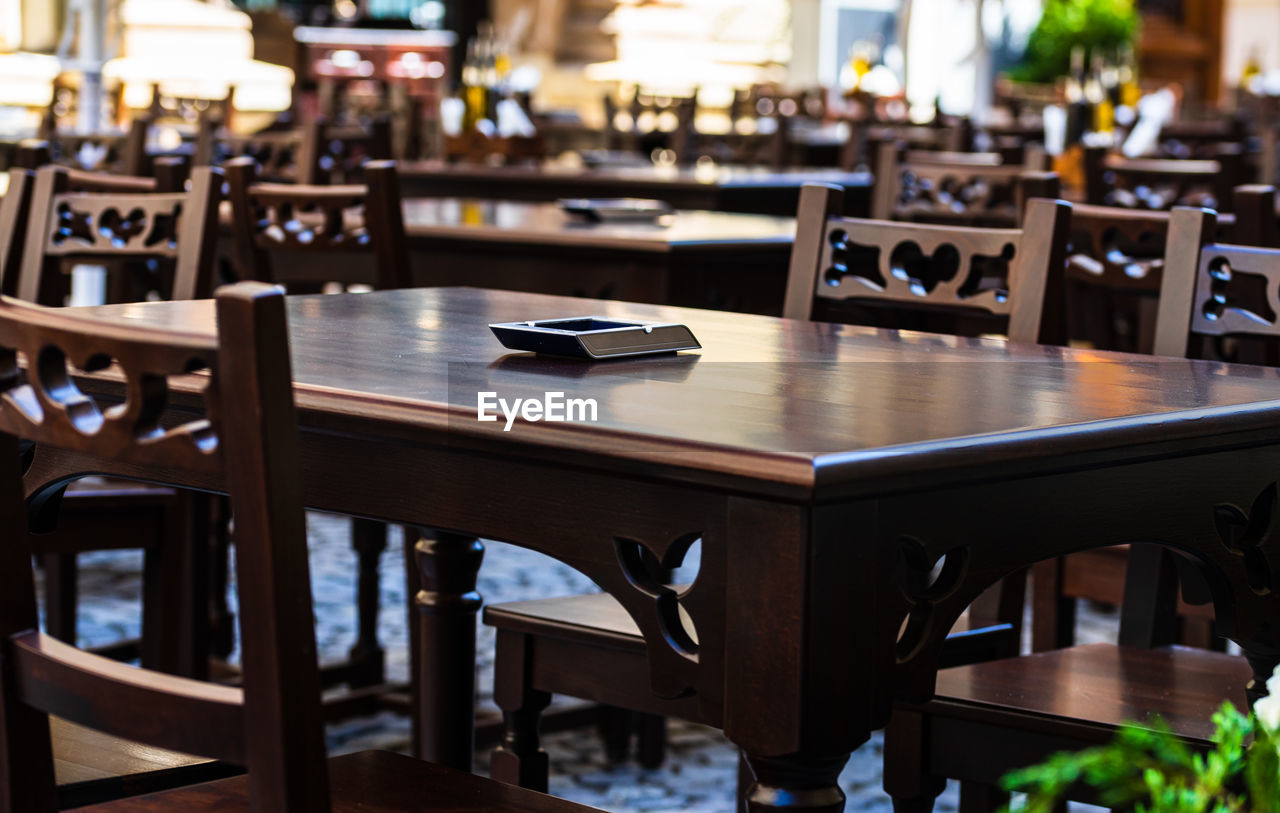 EMPTY CHAIRS AND TABLES AT RESTAURANT