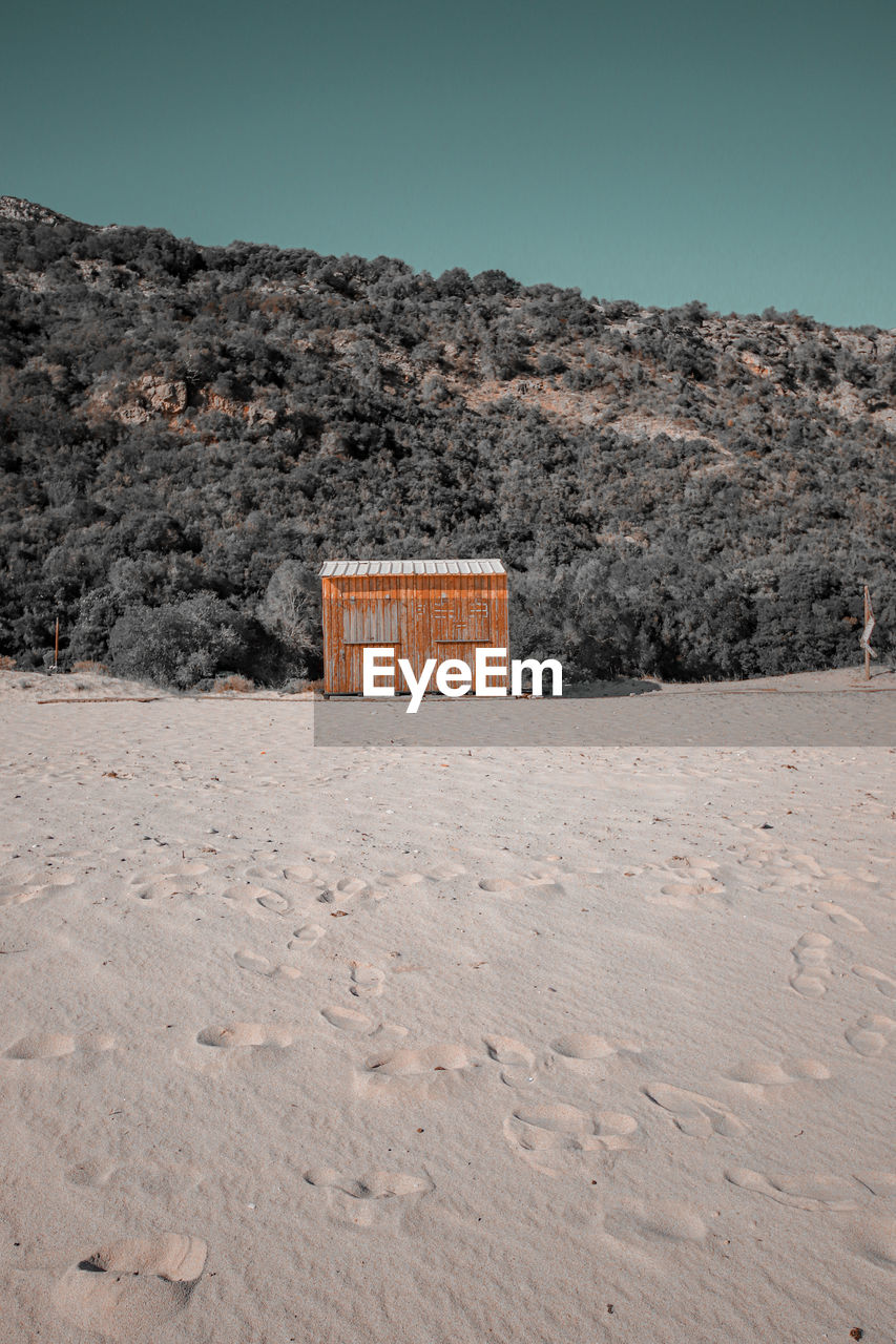 Wooden yellow hut on the beach