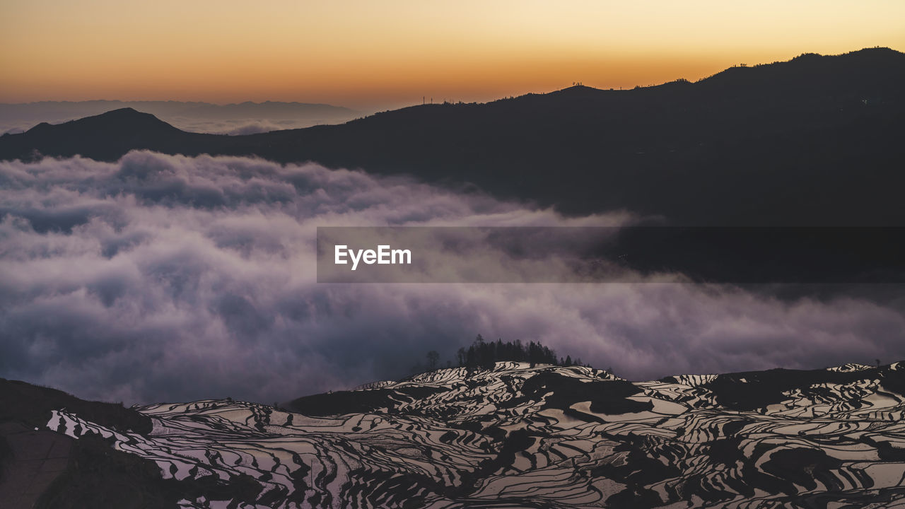 Scenic view of mountains against sky during sunset