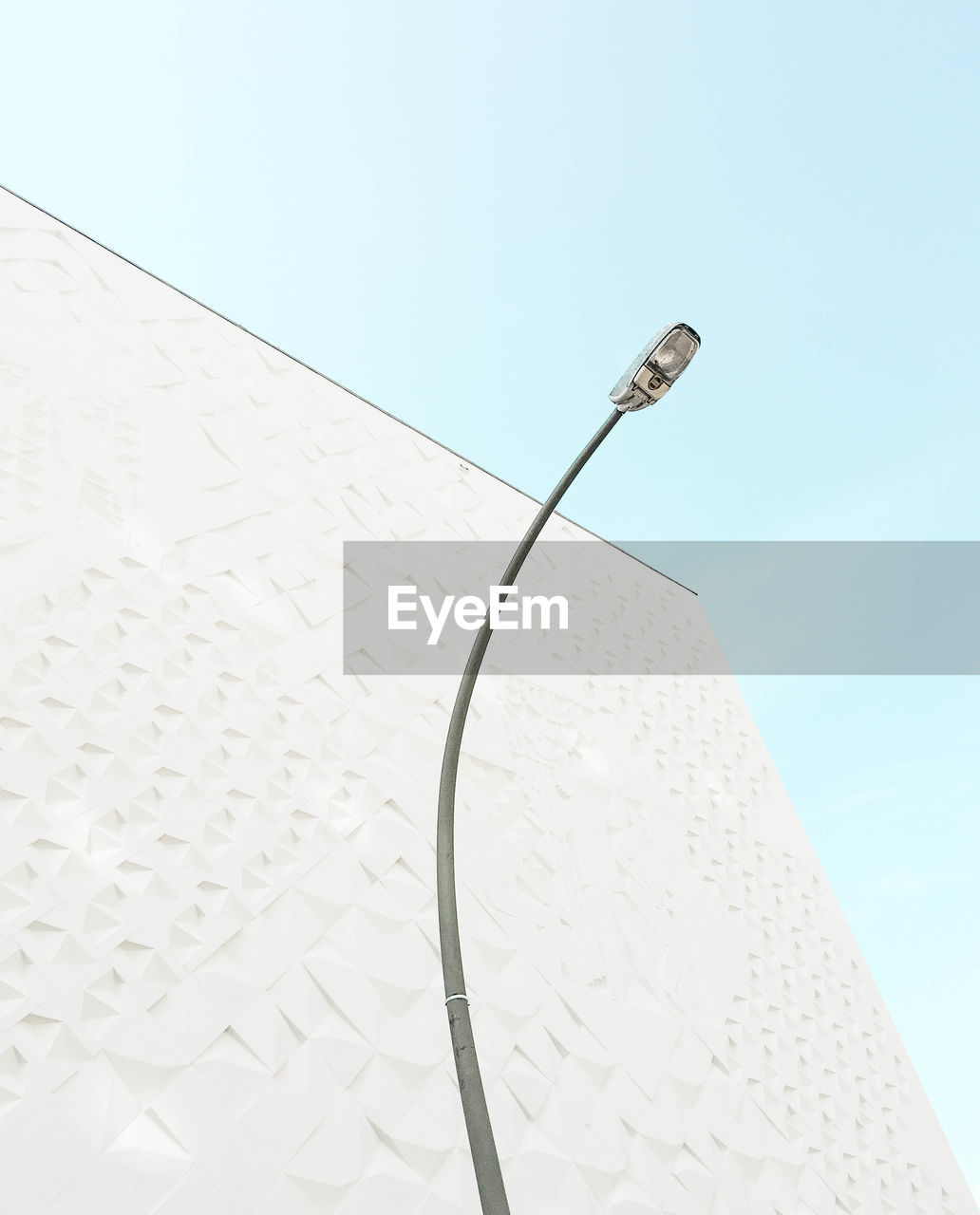 Low angle view of street light and building against sky