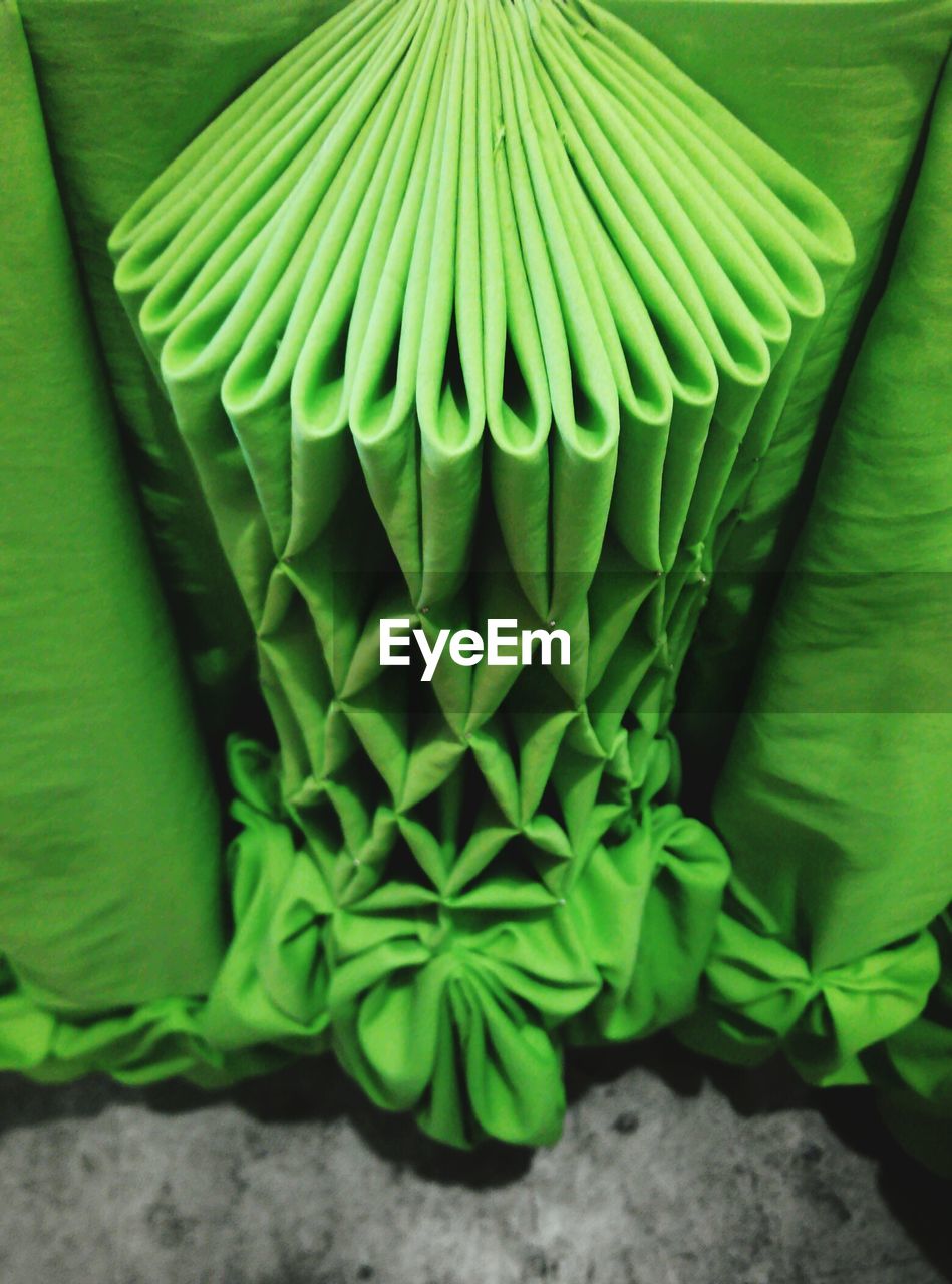 High angle view of folded green tablecloth