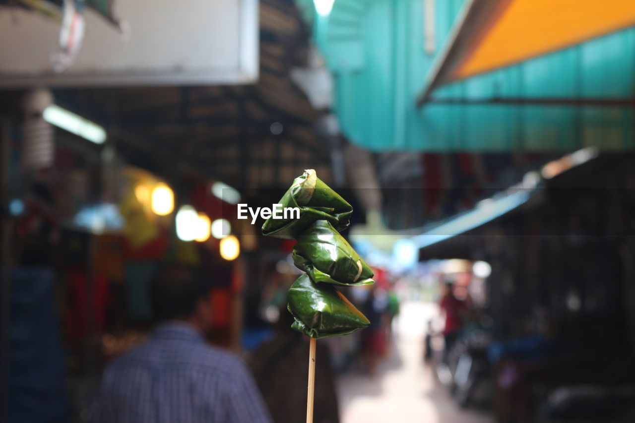 Close-up of paan against crowd at market