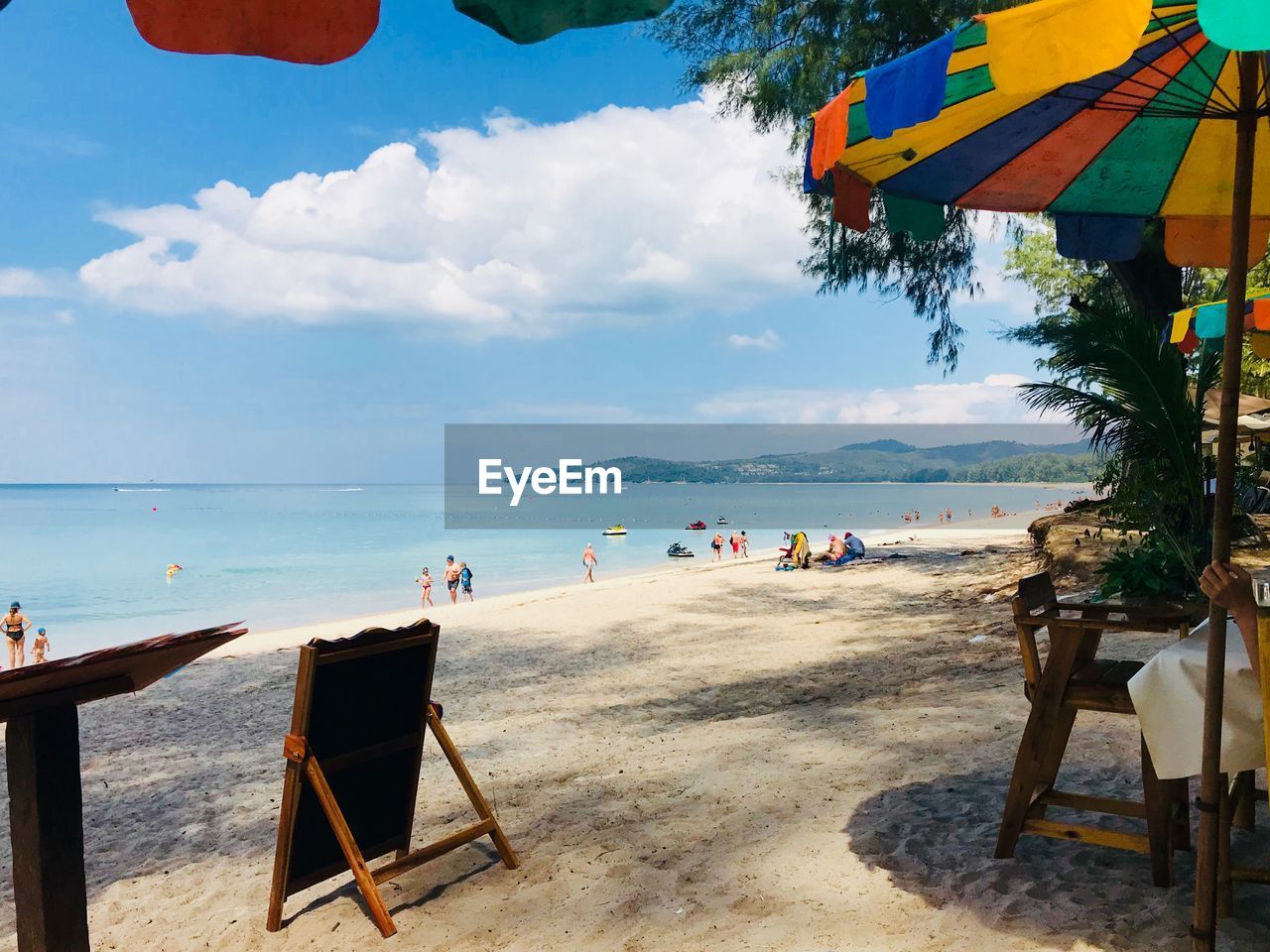 People at beach against sky