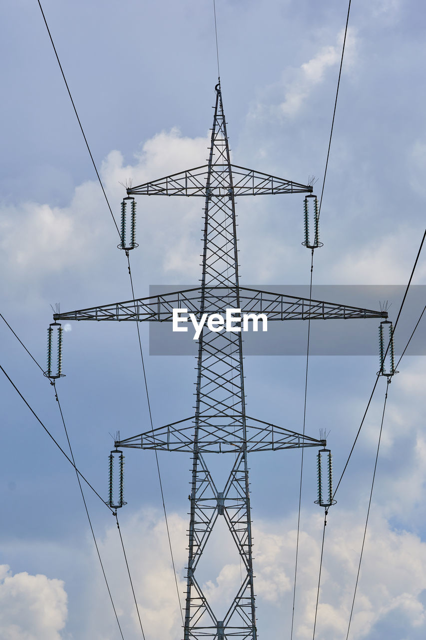 Low angle view of electricity pylon against sky