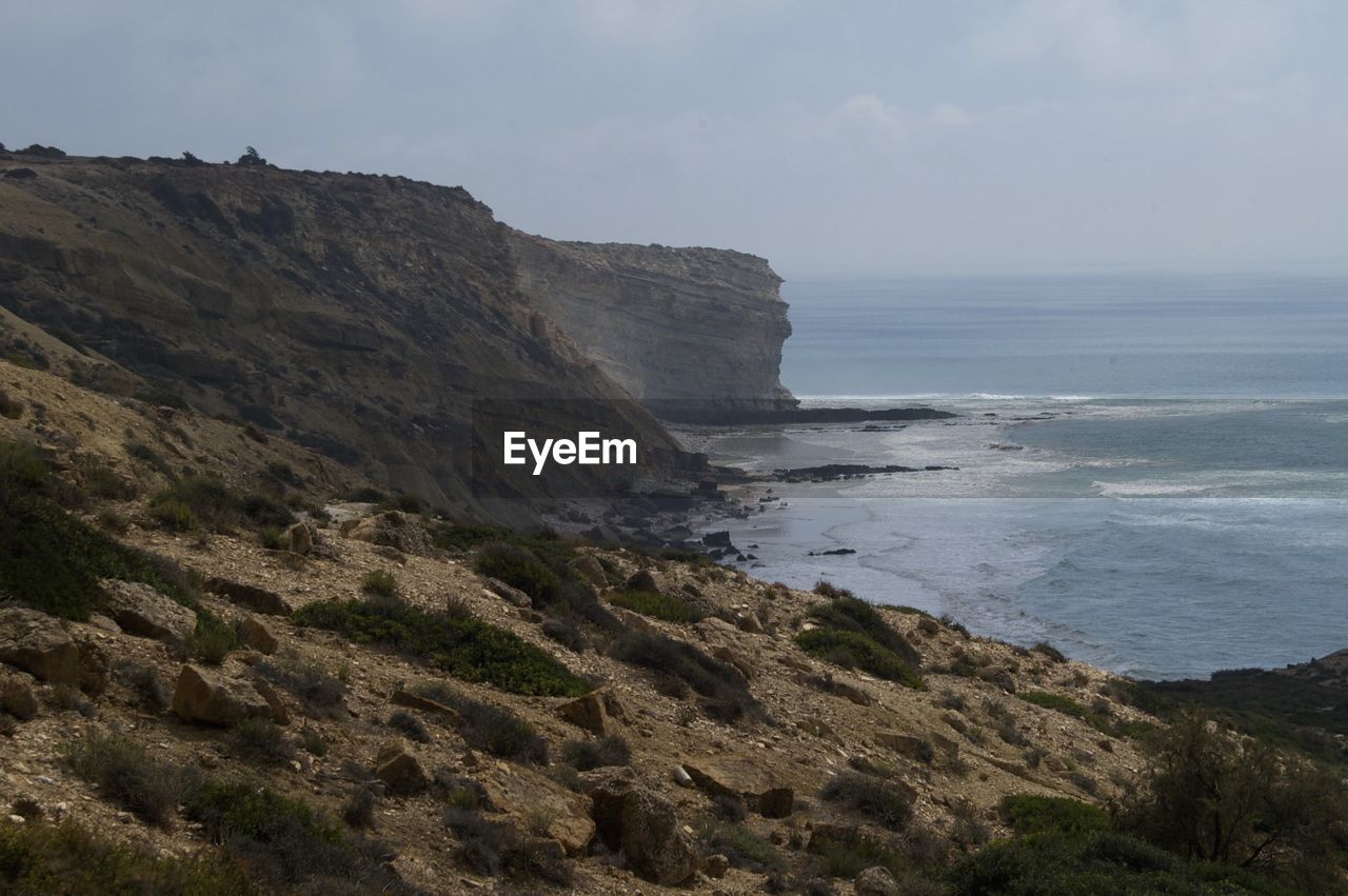 SCENIC VIEW OF CLIFF BY SEA