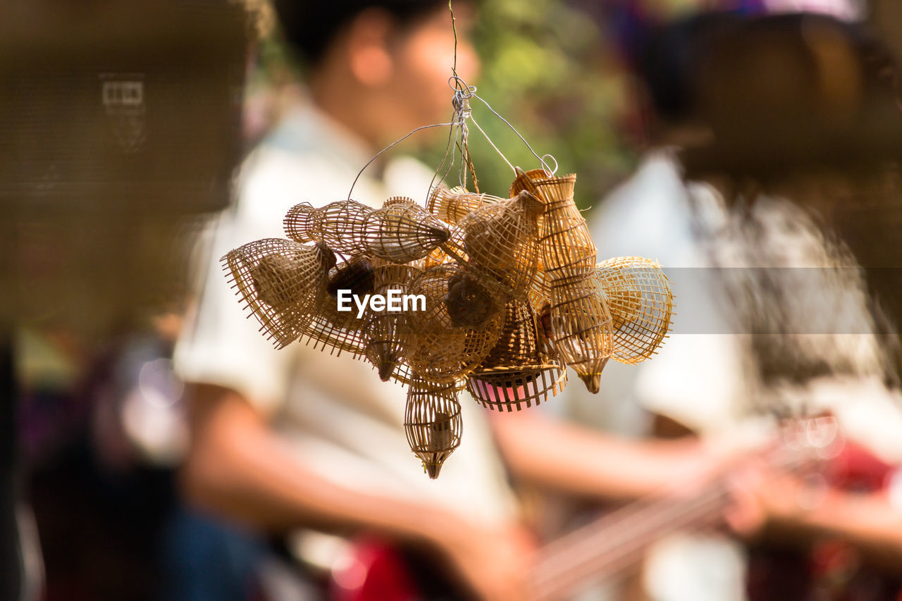 Close-up of basket making hanging outdoors