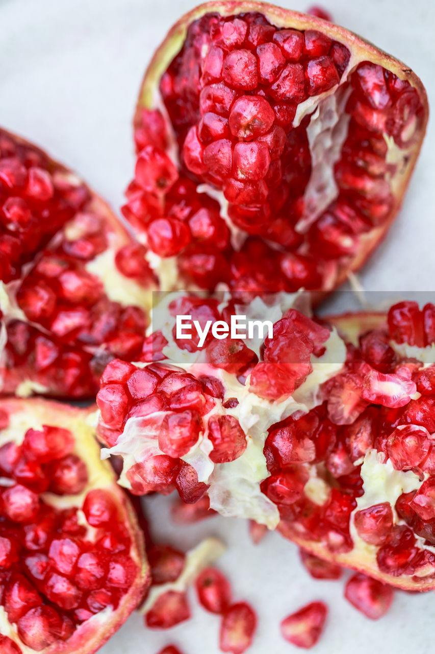 food and drink, food, pomegranate, healthy eating, fruit, plant, red, freshness, wellbeing, seed, pomegranate seed, berry, produce, no people, berries, studio shot, antioxidant, close-up, cross section, juicy, high angle view, vitamin, ripe, indoors, raspberry