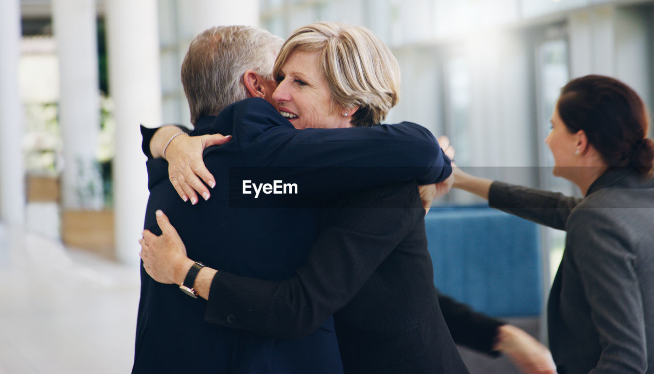 Business people hugging at office