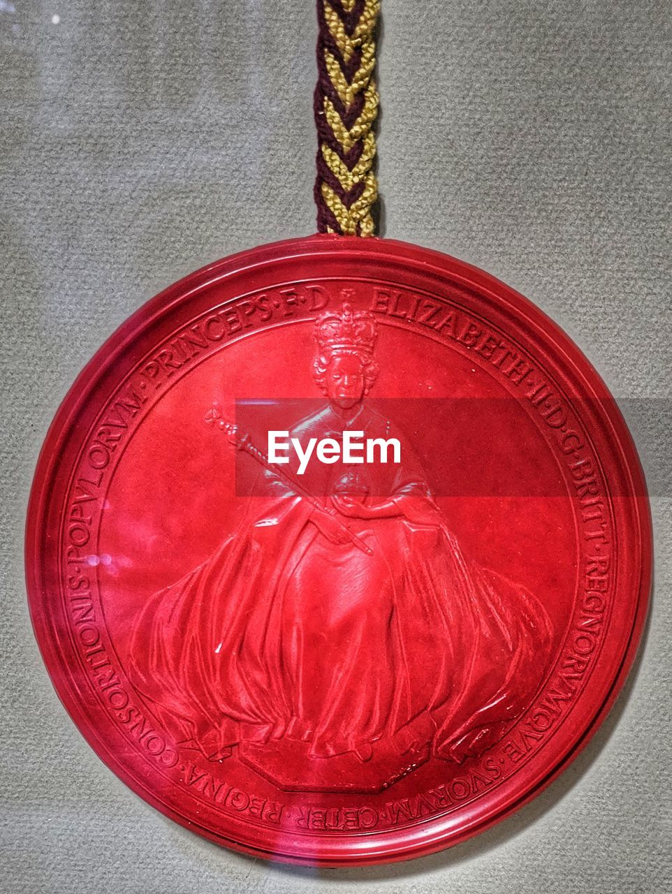 red, medal, close-up, no people, indoors, single object, pendant, metal, award, still life, hanging