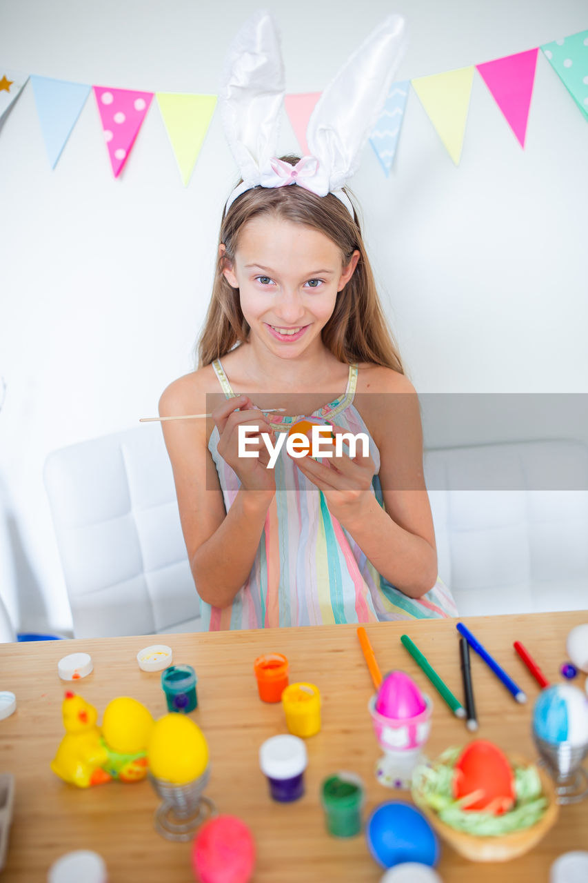 Portrait of happy girl on table