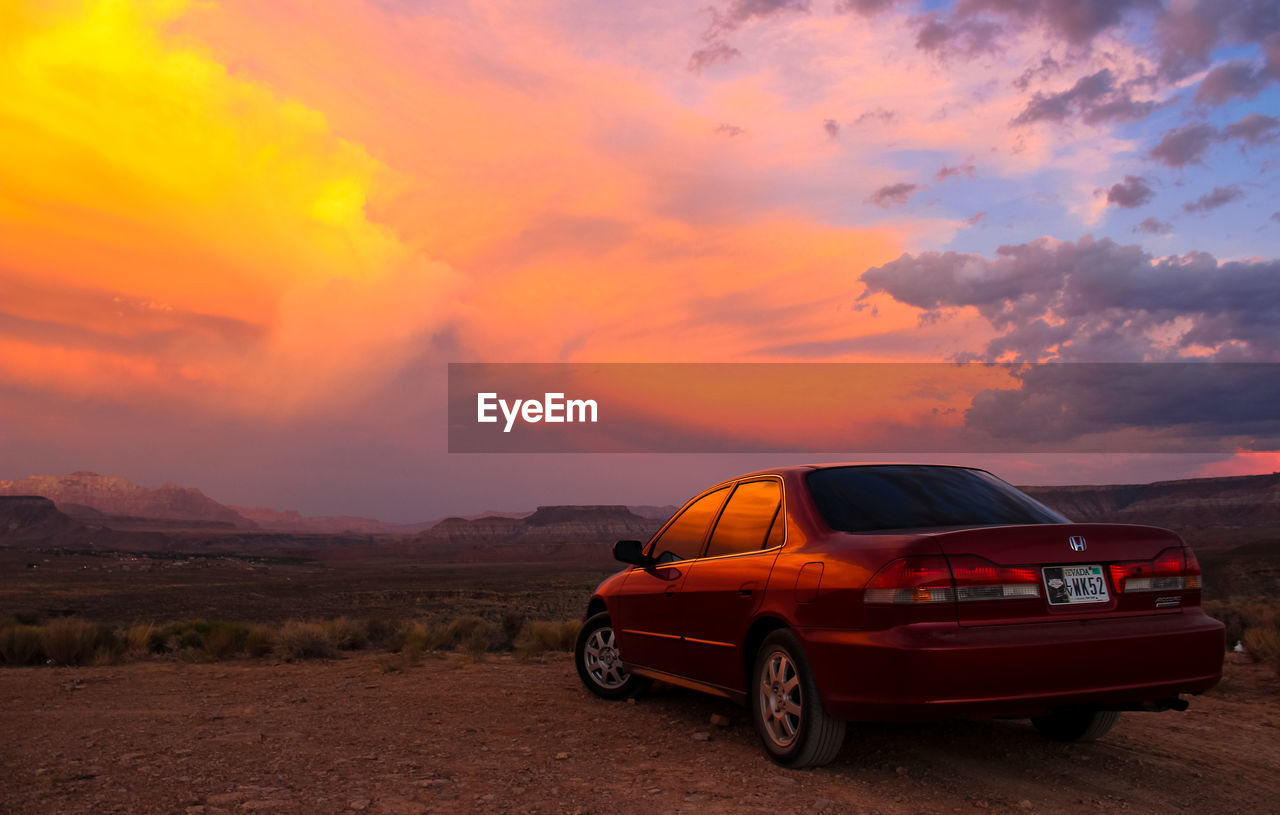 VINTAGE CAR ON LANDSCAPE AGAINST SKY