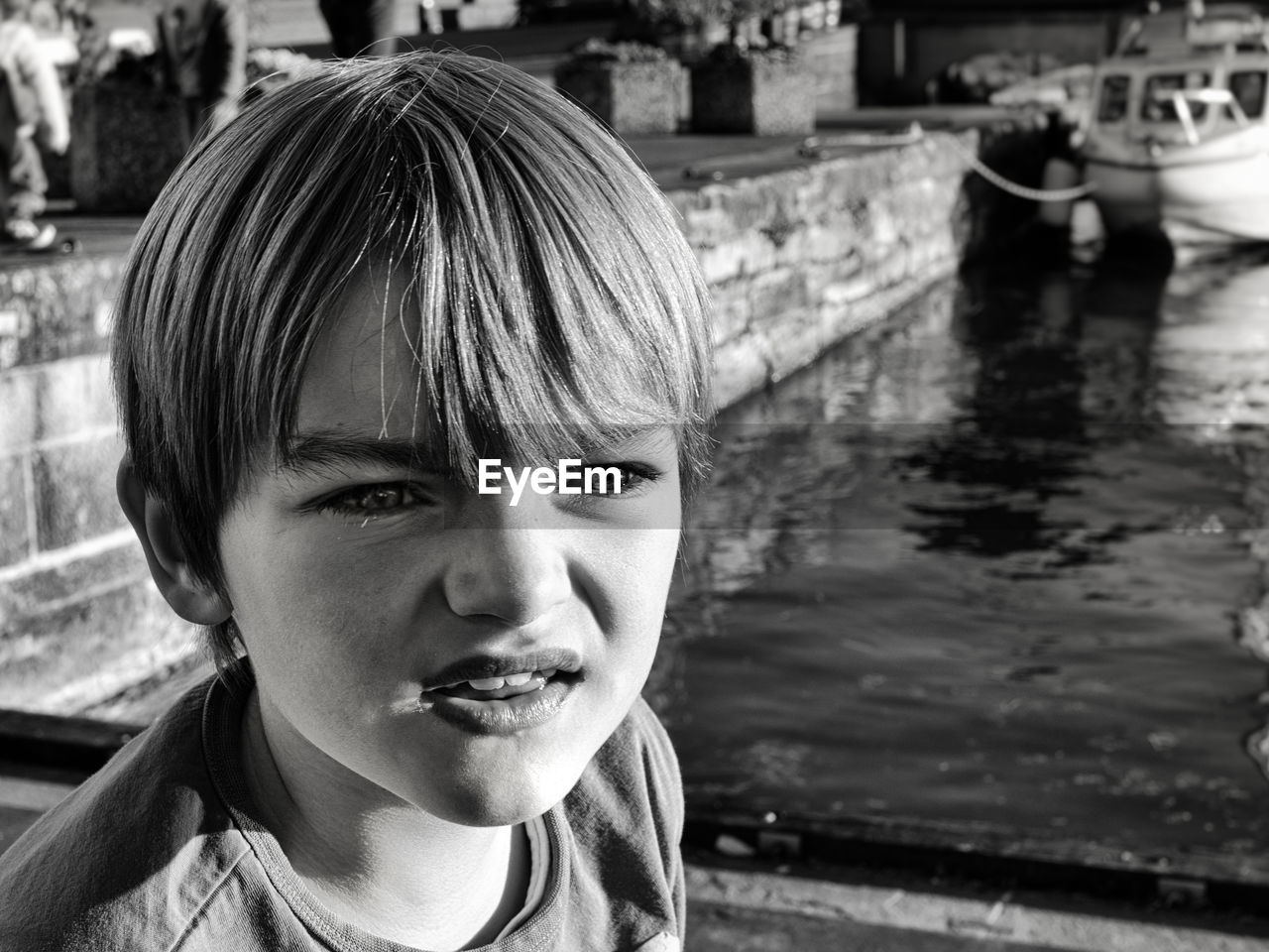 Close-up of boy looking away by canal