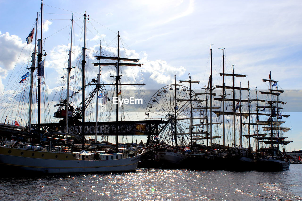 SAILBOATS MOORED IN SEA