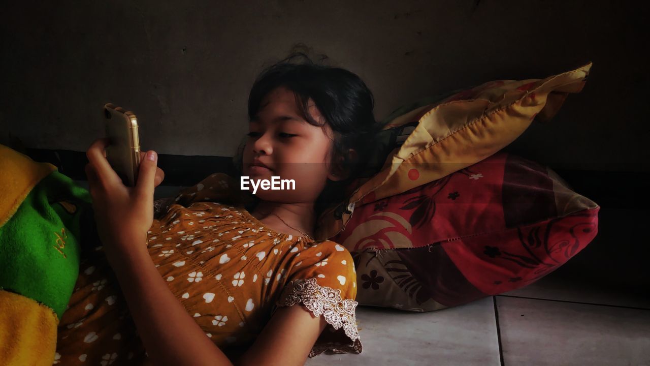 Little girl with cellphone in leisure time