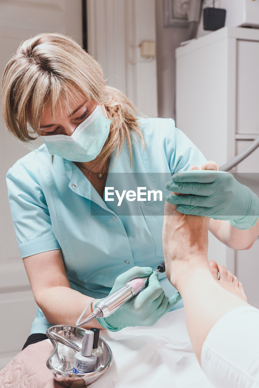 Chiropodist with patient at clinic