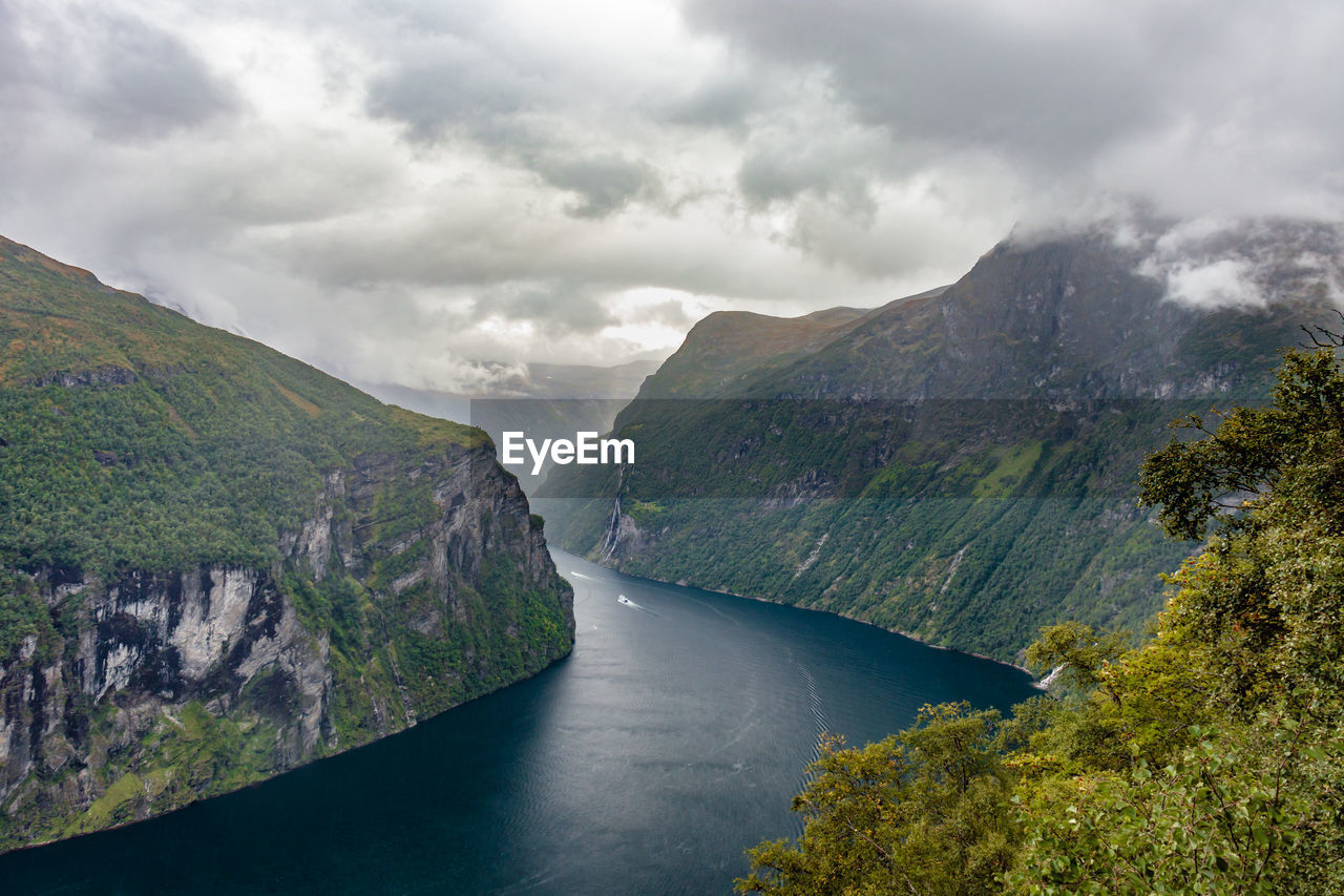 Scenic view of river amidst mountains against sky