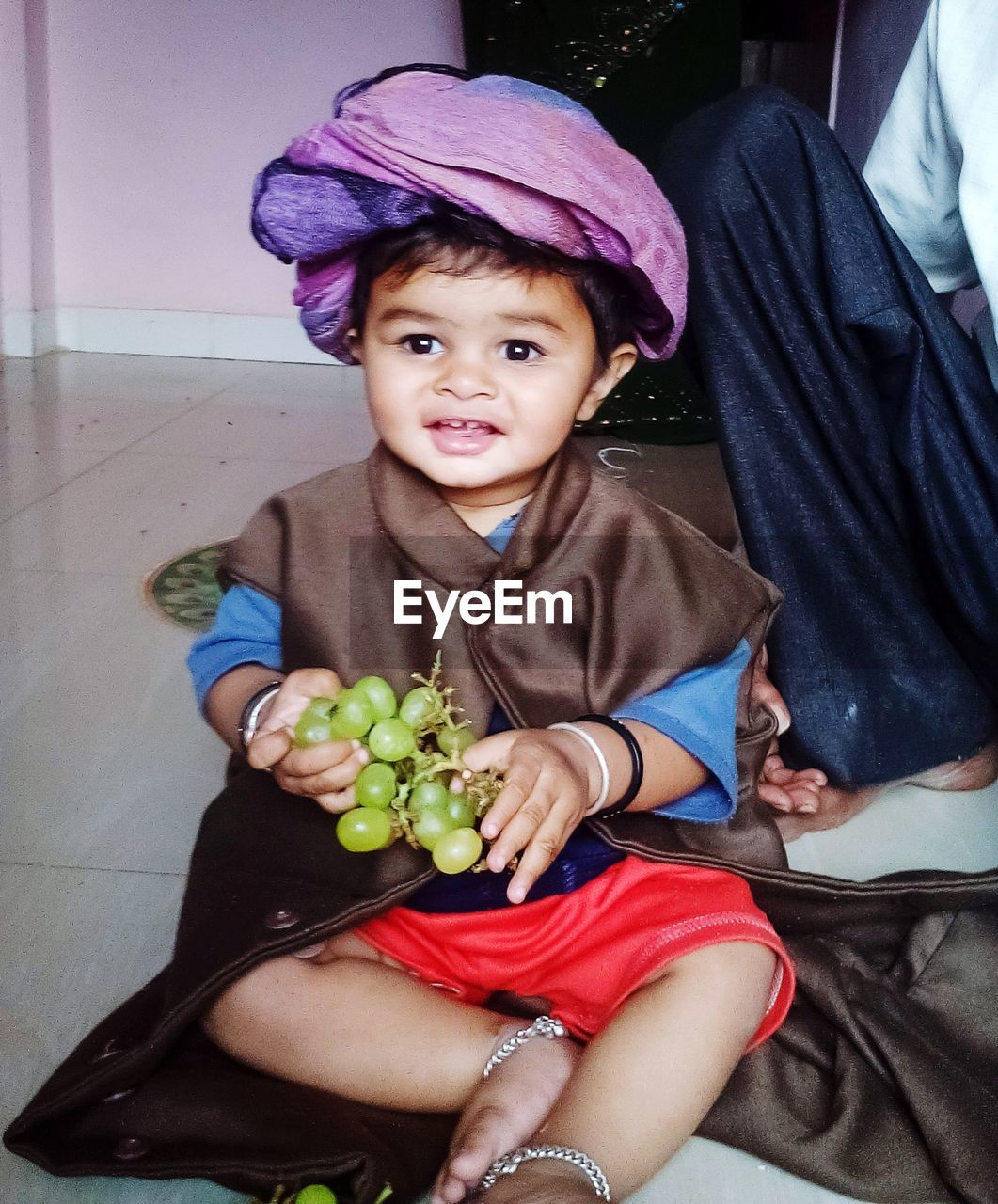 PORTRAIT OF CUTE BABY BOY SITTING AT HOME