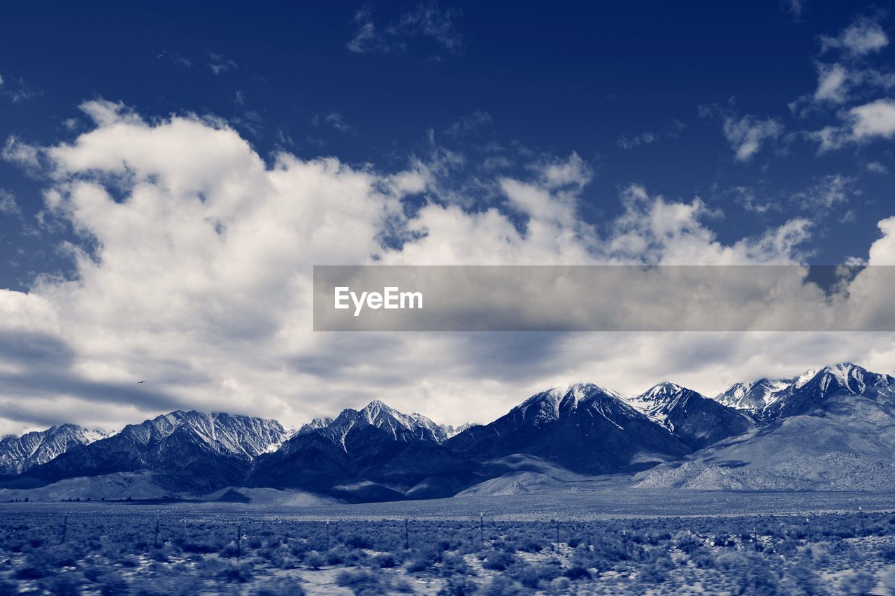 Scenic view of snow covered mountains against sky