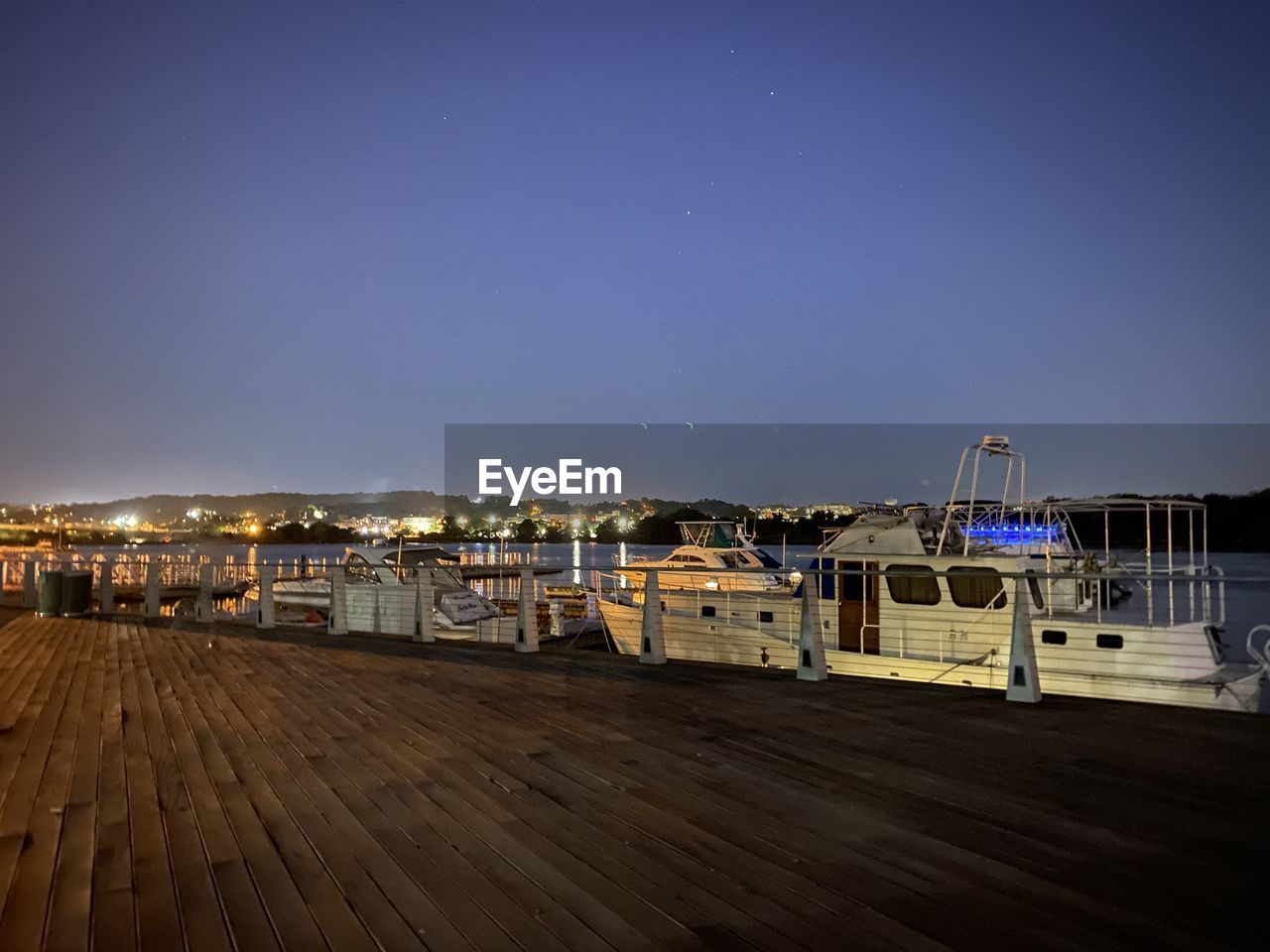 Illuminated buildings against clear sky at night