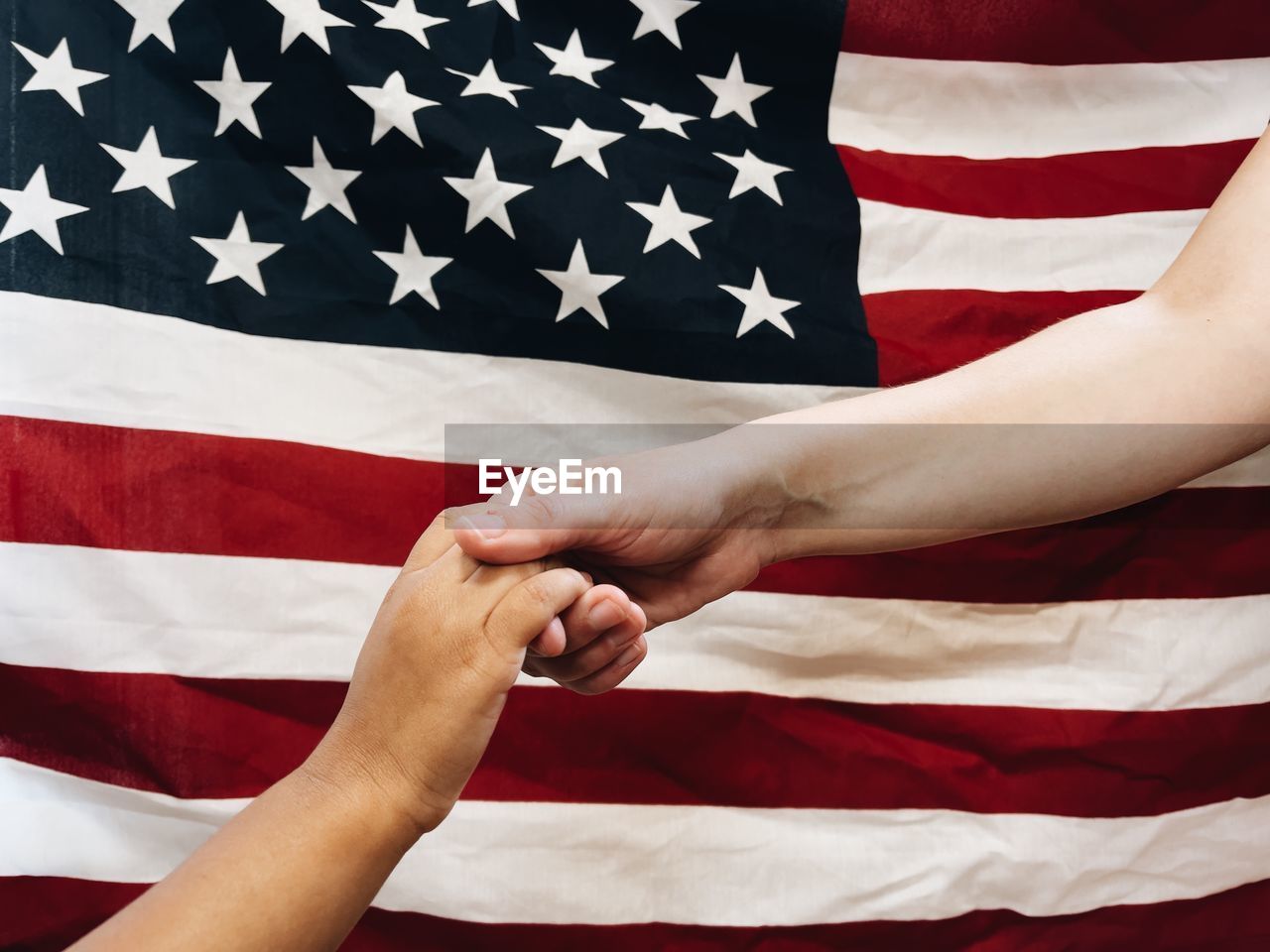 African american man and caucasian woman holding hands or shaking hands showing  togetherness