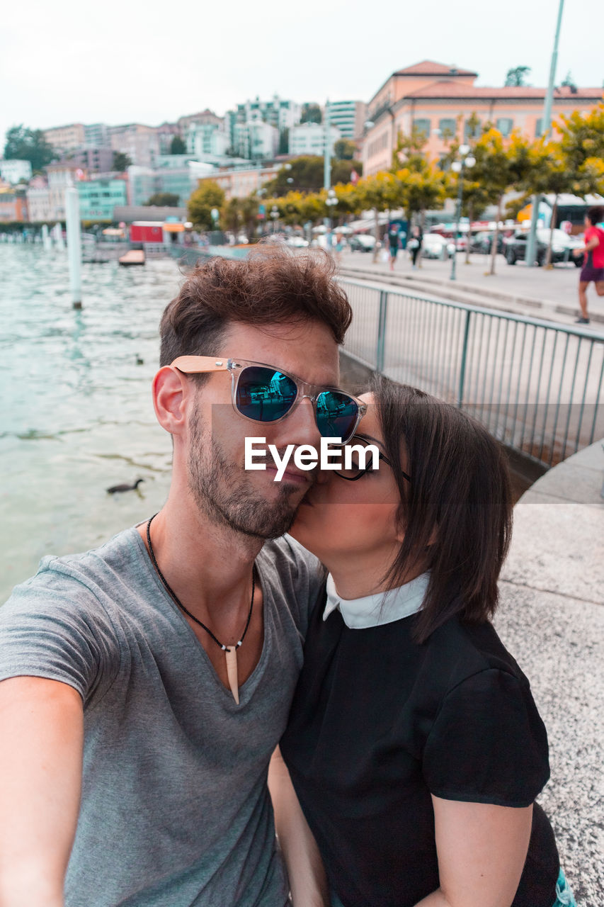 Portrait of couple embracing while standing outdoors