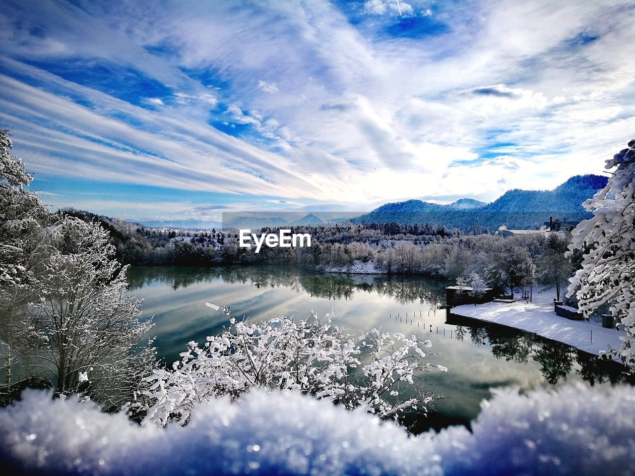 SCENIC VIEW OF FROZEN LAKE BY MOUNTAINS AGAINST SKY