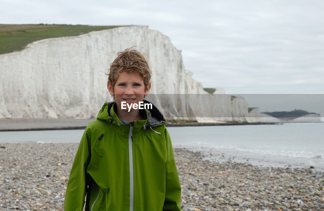 Portrait of smiling boy standing on beach