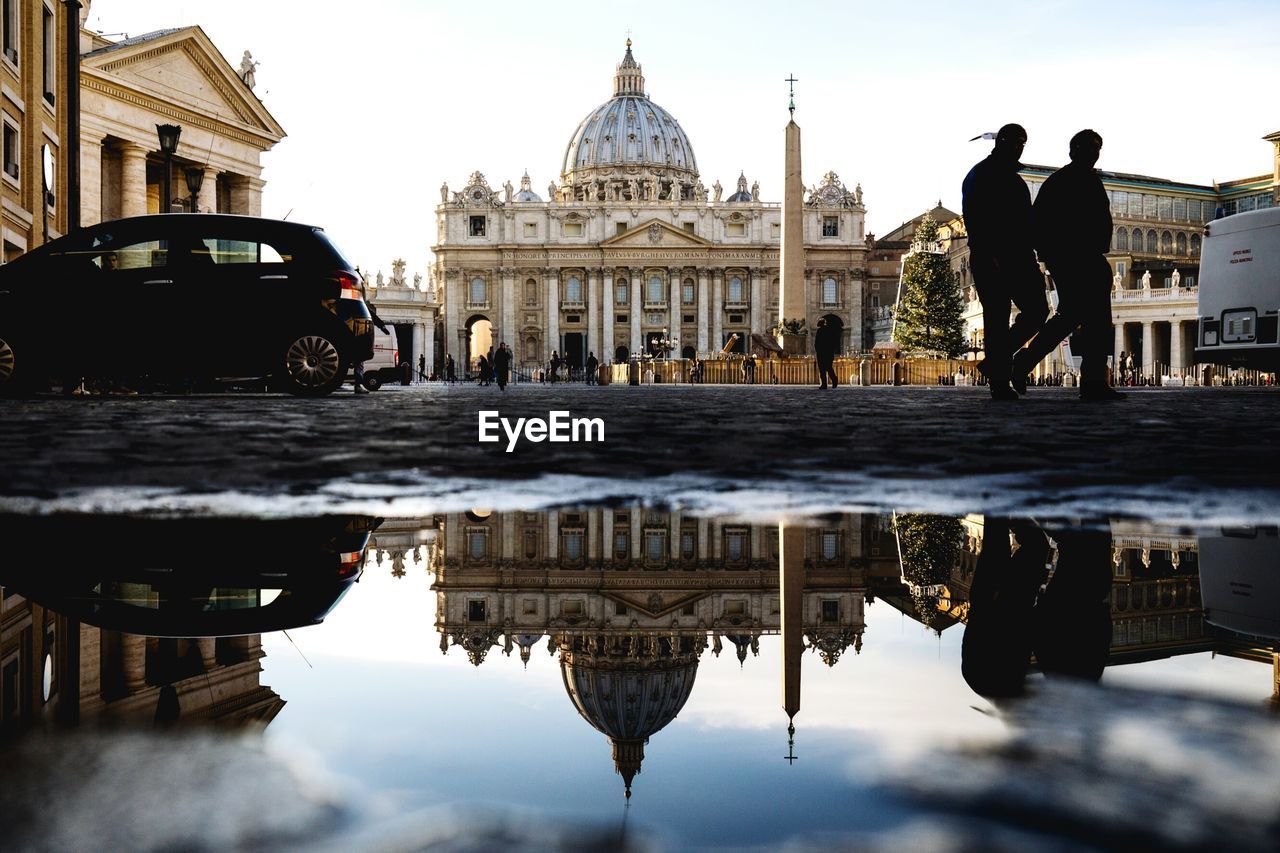 Reflection of st peter basilica on puddle