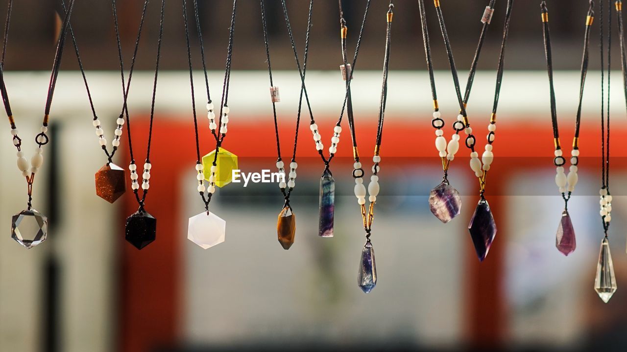 LOW ANGLE VIEW OF DECORATION HANGING FOR SALE AT MARKET STALL