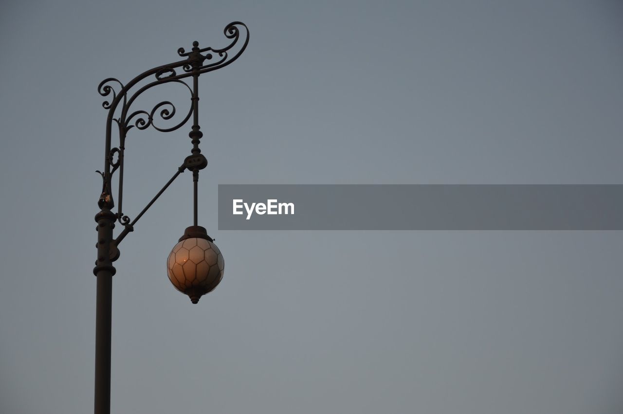 Low angle view of lantern against clear sky