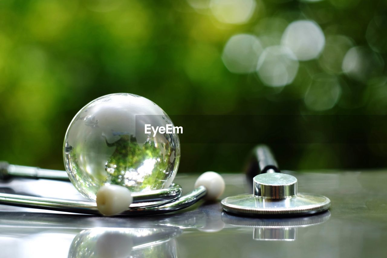 Stethoscope and crystal ball on table
