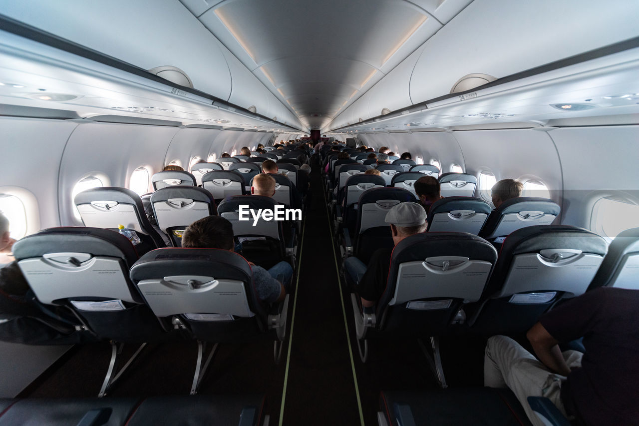 PEOPLE SITTING IN AIRPLANE