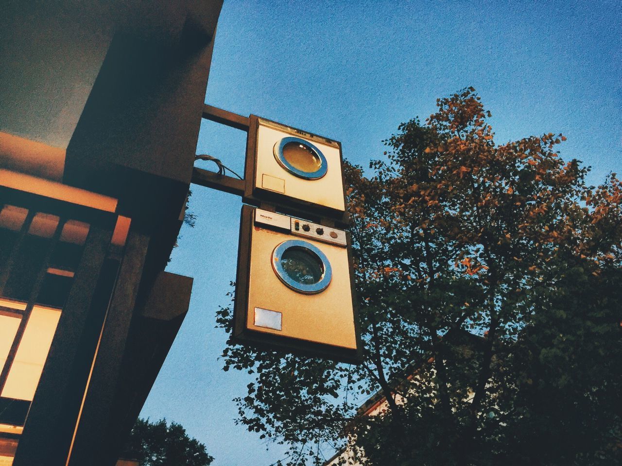 Low angle view of washing machine sign by building