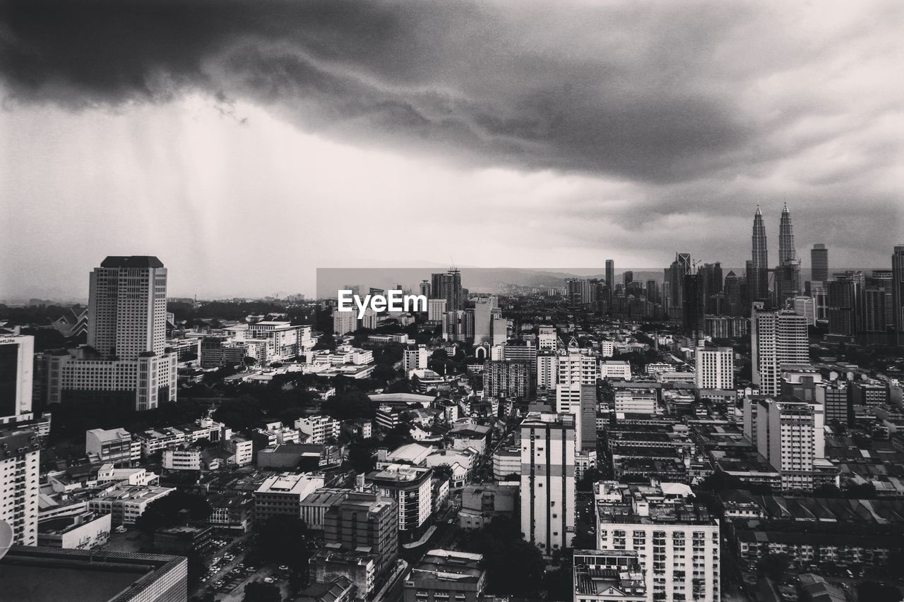 Cityscape against cloudy sky