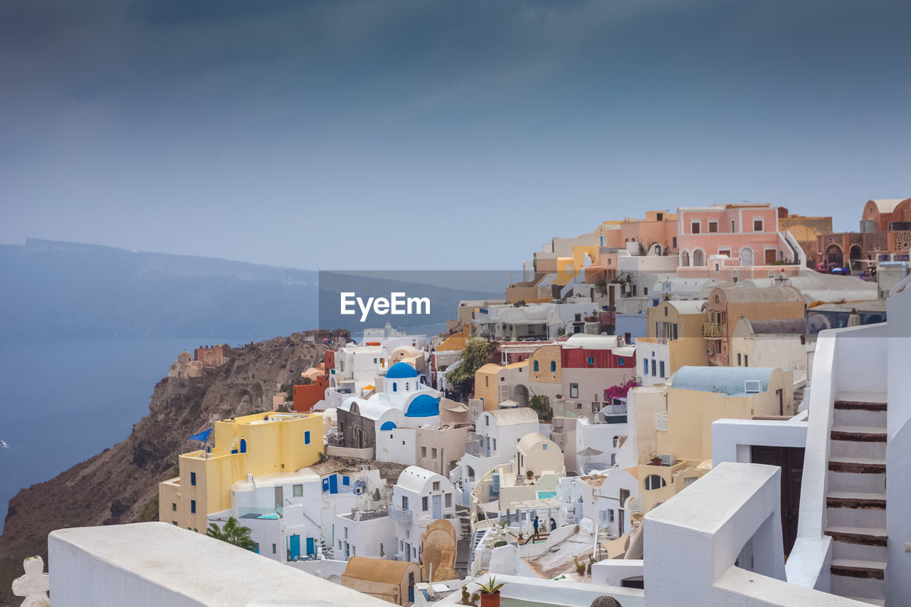 High angle view of townscape by sea against sky