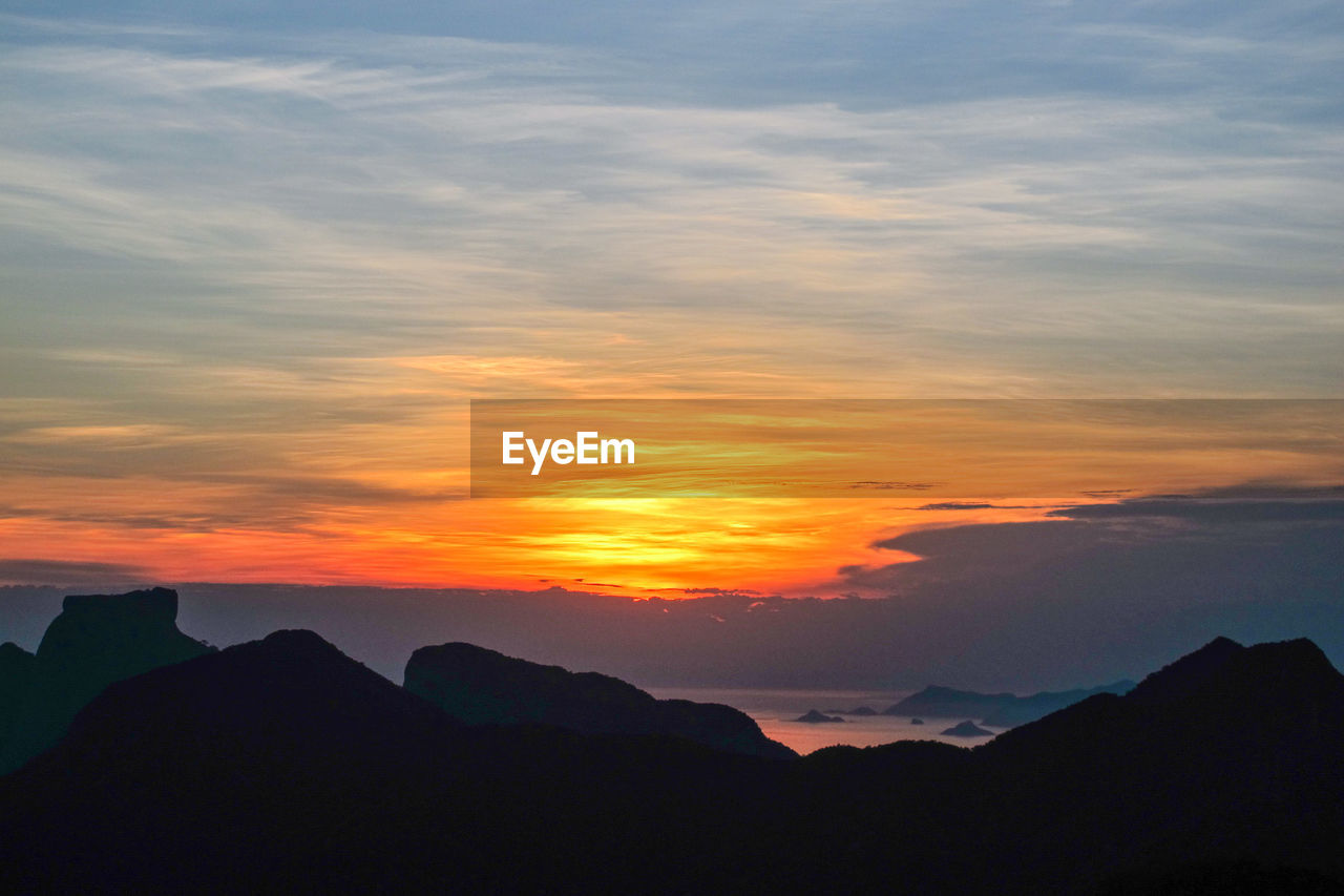 Scenic view of silhouette mountains against sky during sunset