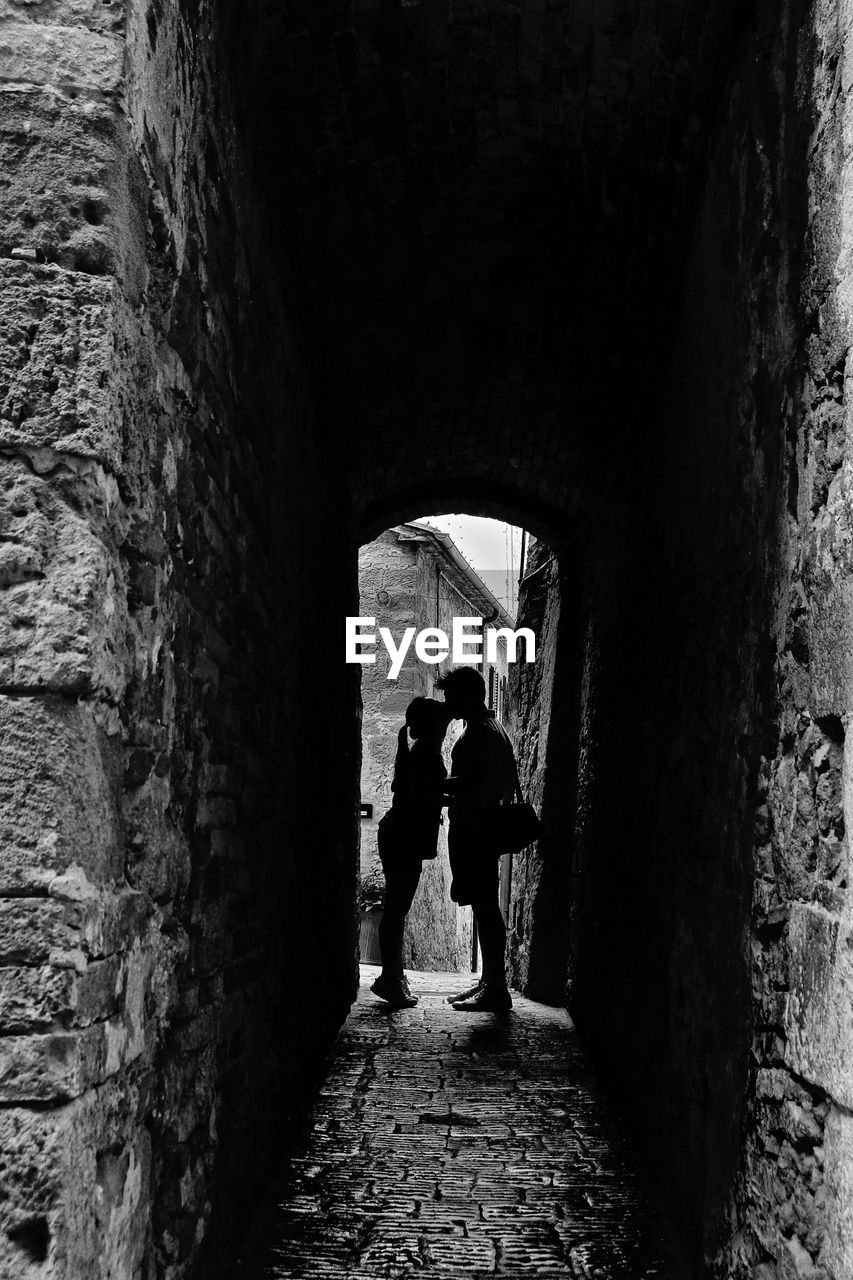 WOMAN WALKING IN TUNNEL