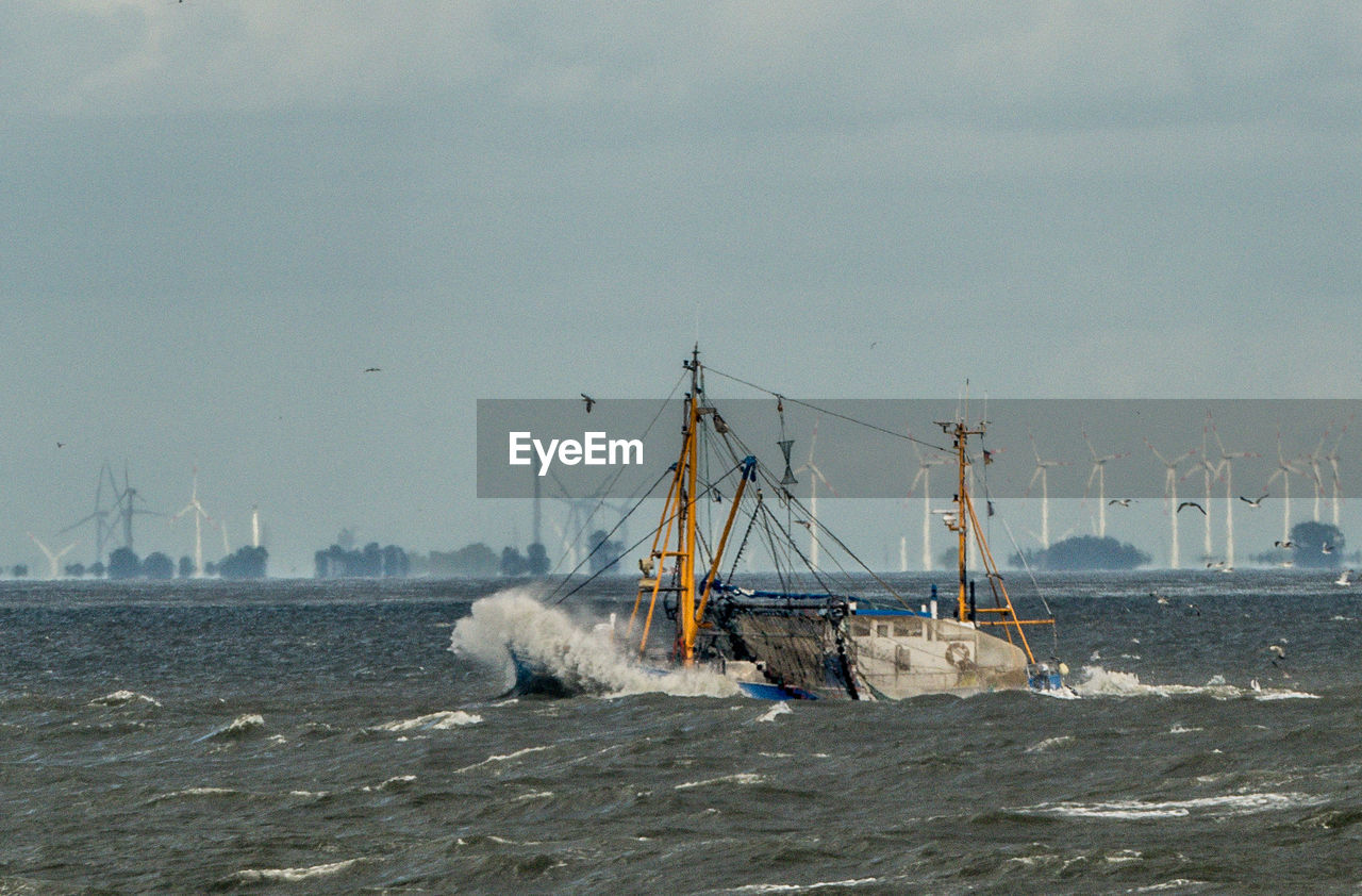 SAILBOAT IN SEA AGAINST SKY