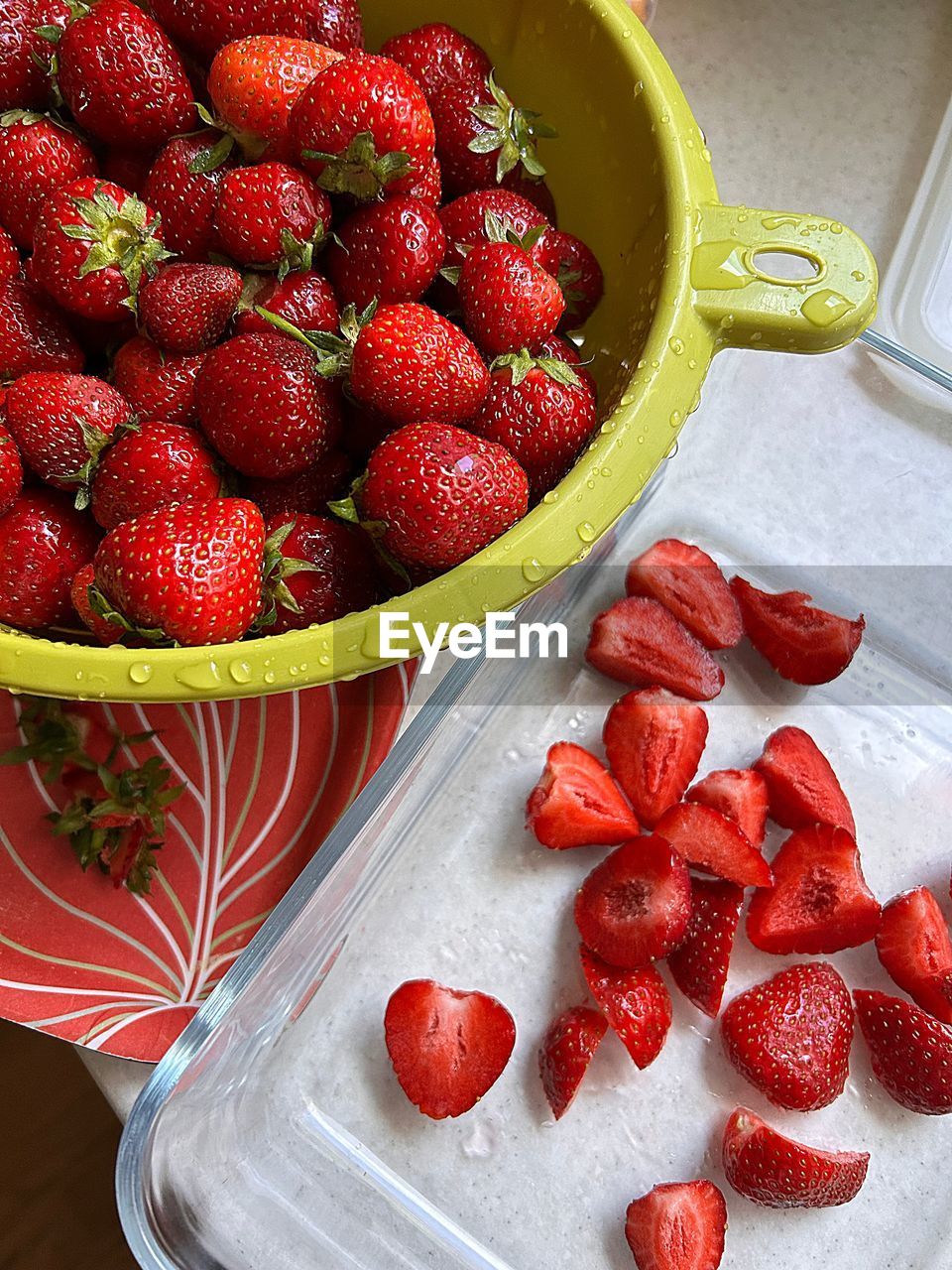 Fresh strawberries, peeling strawberries, washed fruits, slicing strawberries for salad, macedonia 